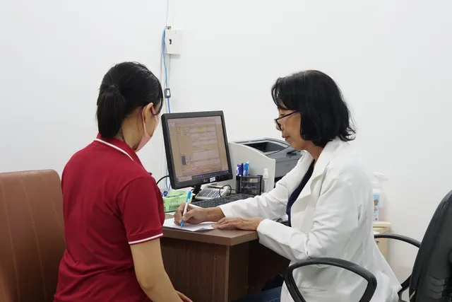 Doctor examining a patient at Ky Hoa Medical Center